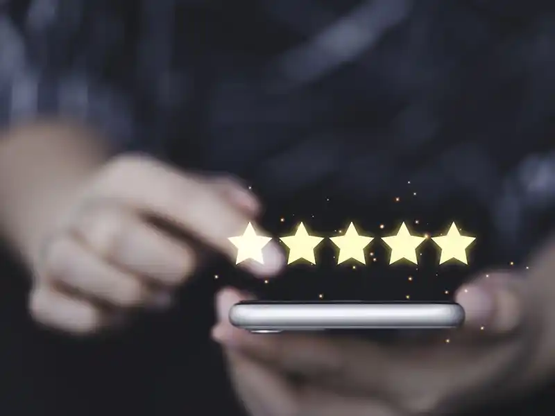Person leaving a 5-star review on their phone