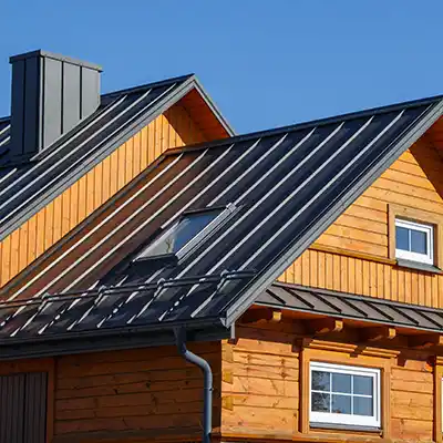 Wood exterior home with a black metal roof